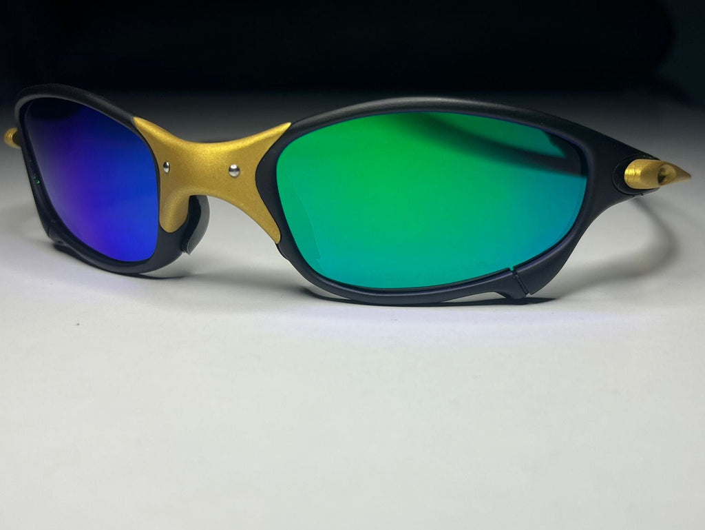 Sunglasses with gold frame and green lenses on a white background