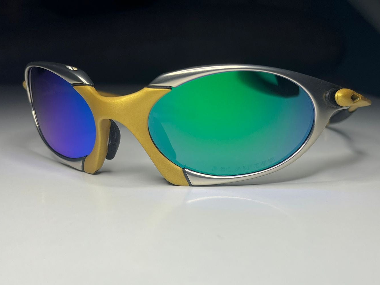 Sunglasses with colorful lenses on a white surface