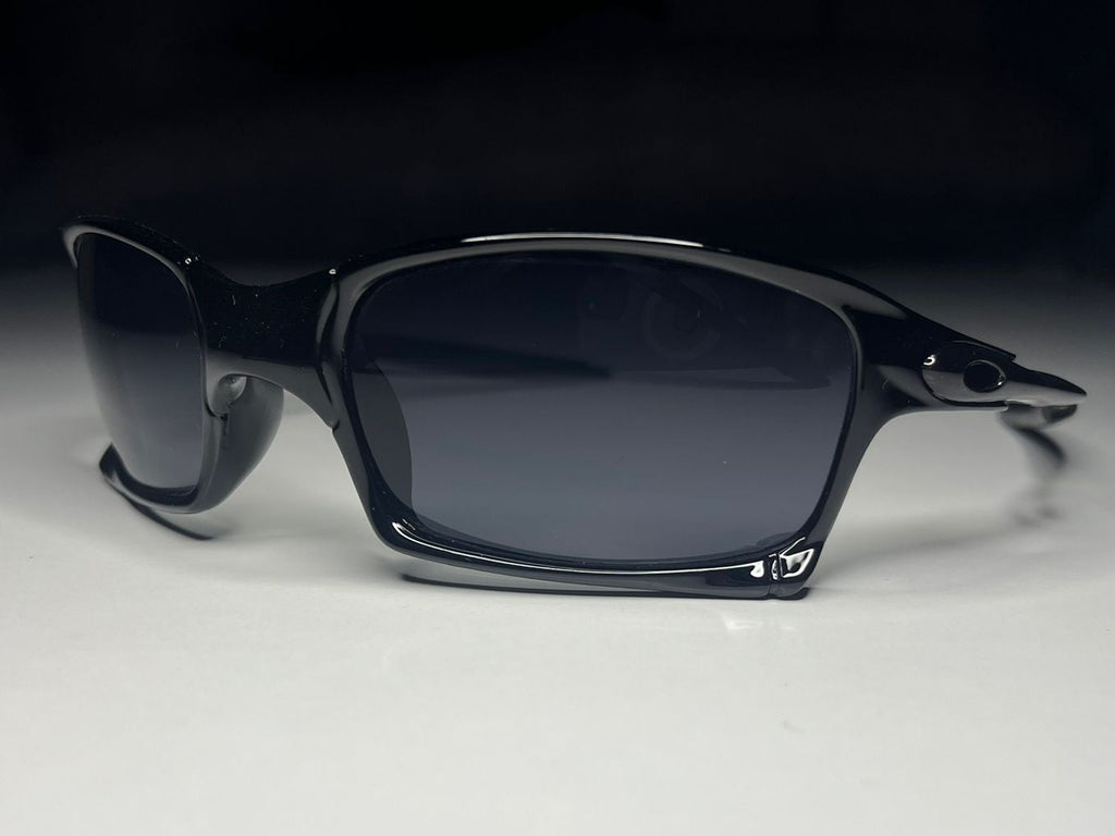 Sunglasses with dark lenses on a light gray surface