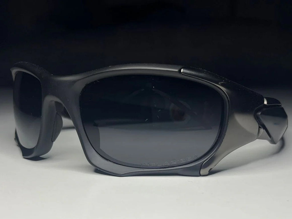 Black sunglasses with dark lenses on a white background