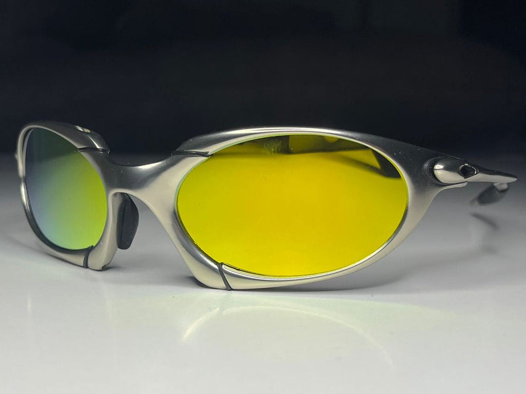 Sunglasses with yellow lenses on a reflective surface