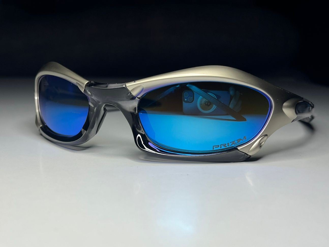 Sunglasses with blue lenses on a white surface
