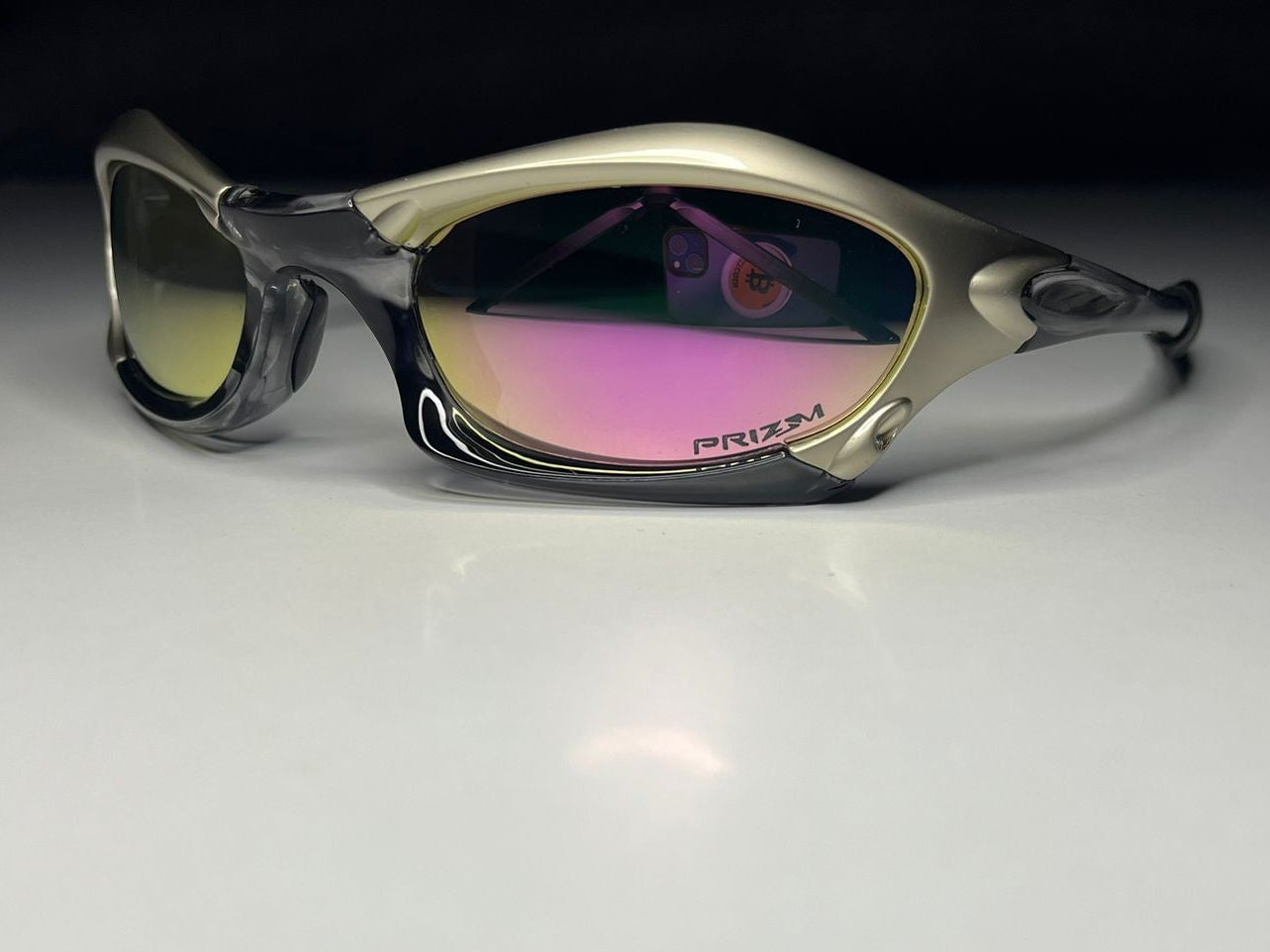 Sunglasses with reflective lenses on a white surface