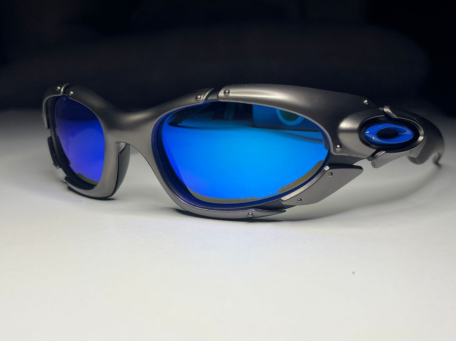 Sunglasses with blue lenses on a white surface