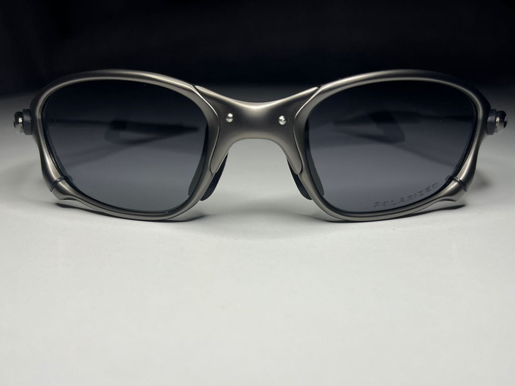 Sunglasses with dark lenses on a light gray background