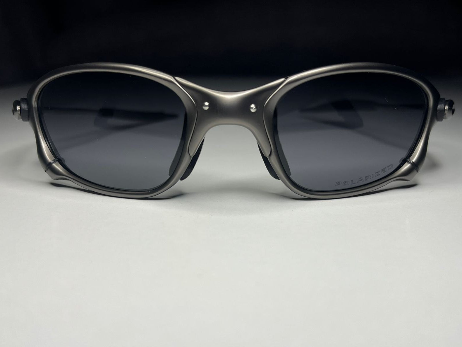 Sunglasses with dark lenses on a light gray background