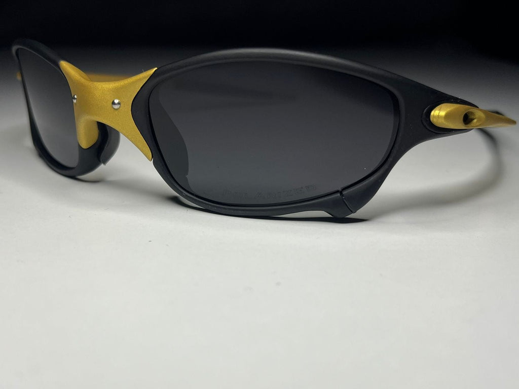Sunglasses with black and gold frame on a white background