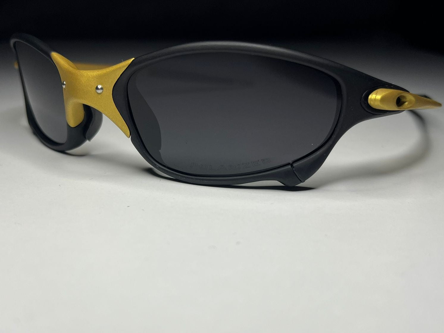 Sunglasses with black and gold frame on a white background