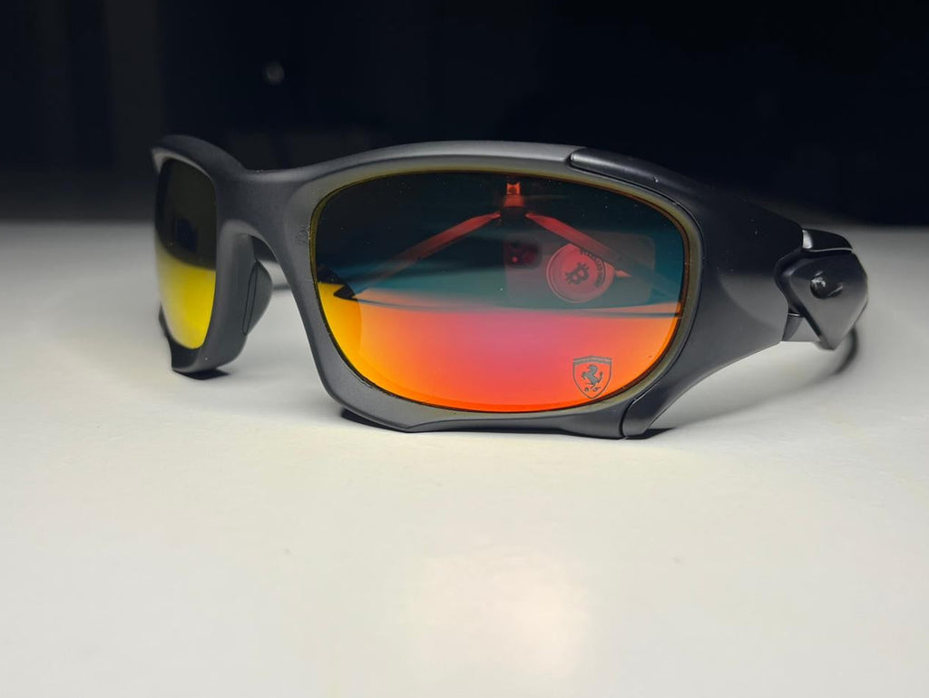 Sunglasses with red-tinted lenses on a white surface