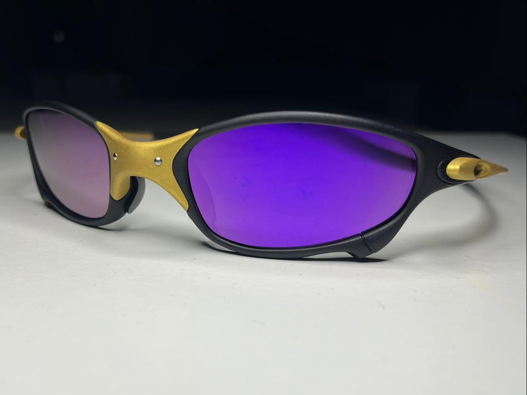 Sunglasses with gold and black frame on a white background