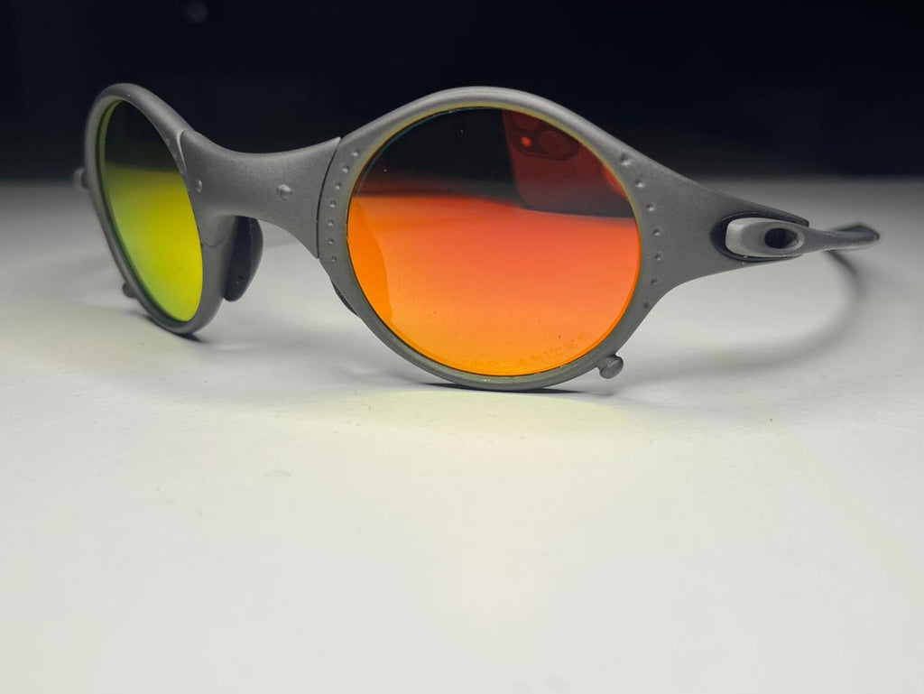 Sunglasses with red and green lenses on a white surface