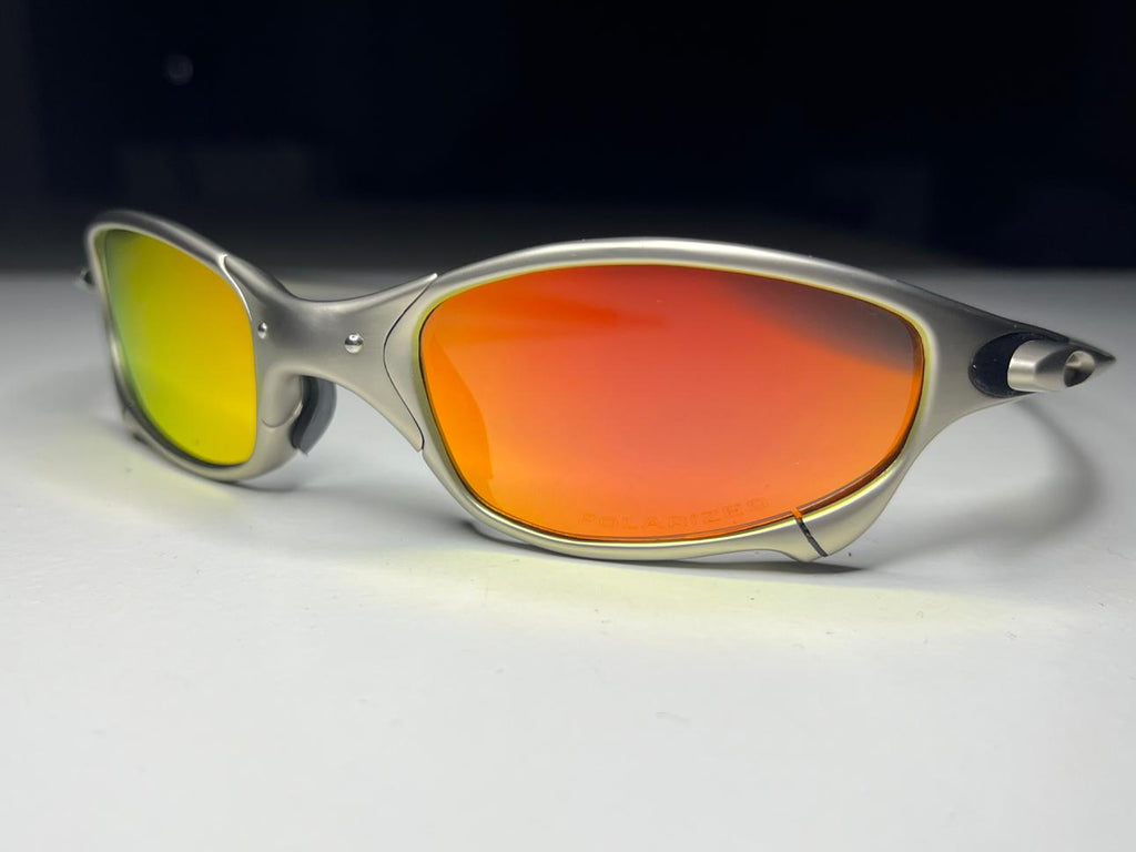 Sunglasses with red lenses and silver frame on a white background