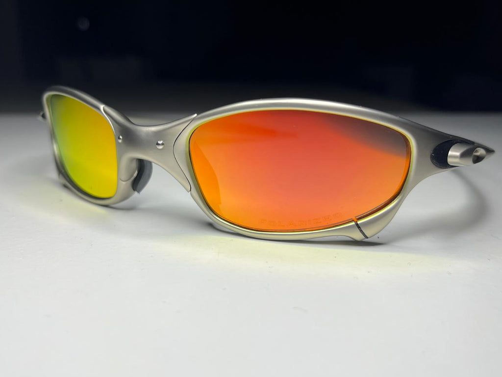 Sunglasses with red lenses and silver frame on a white background